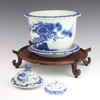 A Chinese circular blue and white porcelain jardiniere with scallop rim, the body decorated birds amongst branches, the drilled base with seal marks, raised on a saucer with seal mark (chip to rim and cracked) 17cm x 23cm, together with 2 blue and white urn lids and an associated hardwood base  