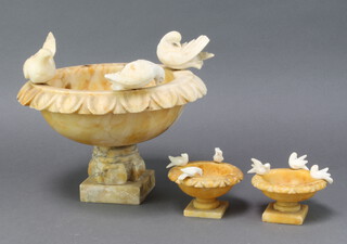 A 1920's circular carved alabaster urn decorated 3 doves, raised on square base 15cm h x 25cm together with 2 similar urns 5cm x 9cm  