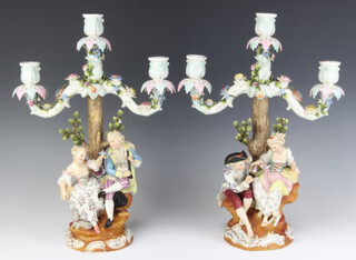 A pair of Sitzendorf 3 light candelabra decorated with figures beneath trees, raised on rococo bases 36cm 