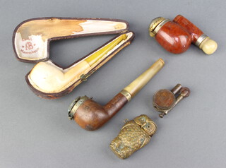A Victorian gilt metal vesta case in the form of an owl 6cm x 3cm (hardstone eyes missing), a Meerschaum carved pipe, 2 other pipes and a lighter in the form of a George V penny 
