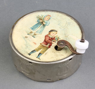 A 19th Century metal musical box of circular form, the paper top decorated Children, the base marked Made in France Fabrication France 2cm x 7cm (winding handle bent) 
