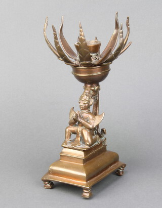 An Eastern bronze incense burner with flower head decoration, the base with a figure of a seated deity 23cm h x 11cm w x 9cm d 