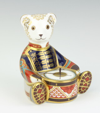A Royal Crown Derby paperweight in the form of a teddy bear drummer with interlaced double M monogram and gold seal to the base 10cm 