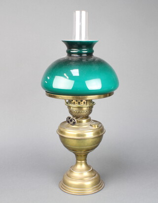A brassed oil lamp with green glass shade and clear glass chimney 50cm h 