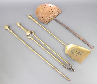 A Victorian brass 2 piece fireside companion set comprising tongs and shovel together with a brass poker and a copper and iron cream skimmer 