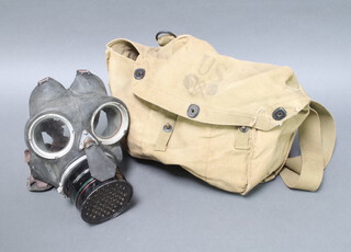 A World War Two civil defence respirator contained in an American lightweight service respirator cloth bag 