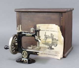 A Singer no.20 manual sewing machine complete with instructions and case, table clamp missing? 