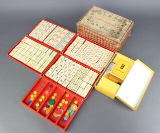 53 19th Century rectangular carved mother of pearl game counters 5cm x 1.5cm, 8 rectangular yellow plastic game counters contained in a pocket Mahjong set 19cm x 23cm and a wood and paper Mahjong set with various counters 