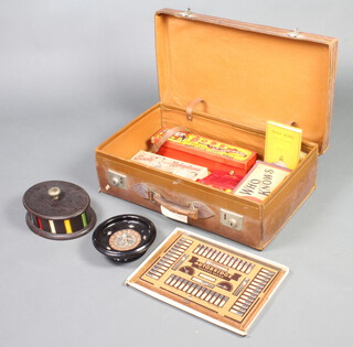 A brown leather suitcase containing an oval oak game counter bank and other game counters, a turned ebonised roulette wheel 6cm x 20cm base marked 7912, a John Bull printing outfit no.20, The Sooty Super Xylophone, an autobridge playing board etc 