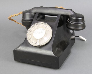 A black Bakelite dial telephone, the base marked AEP 