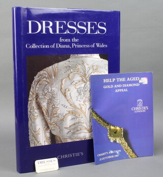 Christies, hardback copy "Dresses From The Collection of Princess Diana" a charity sale conducted by Christies for a non profit bases, together with "Help The Aged Golden Diamond Appeal" charity auction catalogue 21st October 1987, a Christies Dresses From The Collection of Diana Princess of Wales badge  

