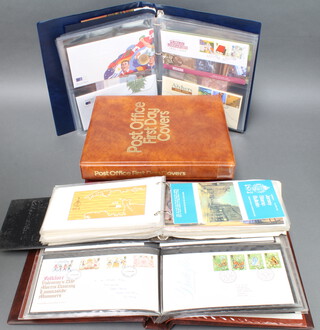 A blue album of Royal Mint Philatelic Numismatic covers together with 4 albums of first day covers 