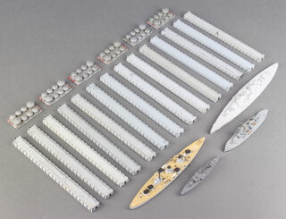 A quantity of Triang breakwaters M827 and a quantity of Triang storage tanks M838 and 3 metal figures of war ships 