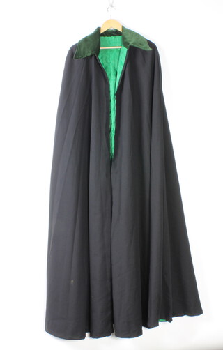 A long black opera coat/mantle with green velvet collar and green silk lining 