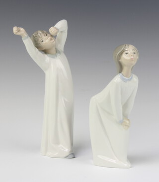 A Lladro figure of a yawning boy wearing a nightshirt, impressed C-14 20cm and 1 other crouching girl in nightgown 