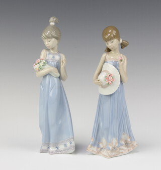 A Lladro figure of a standing girl with bouquet of flowers, impressed 5504 22cm and 1 other girl with flower and bonnet 5648 20cm 