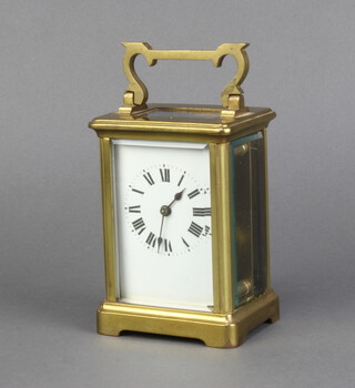 A 19th Century French 8 day carriage timepiece with enamelled dial, Roman numerals, contained in a gilt metal case 