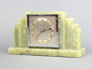 An Art Deco mantel timepiece with square silvered dial marked Armstrong Manchester, contained in a stepped onyx case 