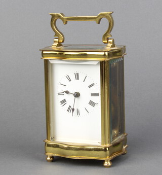 20th Century French carriage timepiece with enamelled dial and Roman numerals contained in a gilt metal case, complete with key 