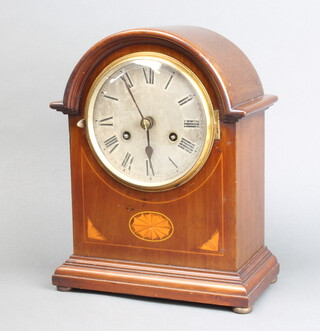 An Edwardian striking bracket clock with silvered dial and Roman numerals contained in an inlaid mahogany arch shaped case, back plate with rising sun mark with H to the centre, complete with pendulum  