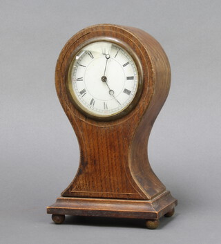 An Edwardian Swiss bedroom timepiece with paper dial and Roman numerals contained in an oak balloon shaped case 