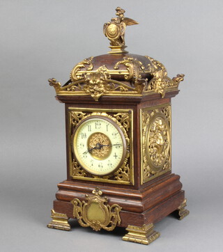 A 19th Century mantel timepiece with enamelled dial and Arabic numerals contained in an oak and gilt metal mounted case 