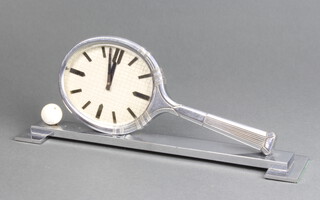 A French Art Deco 8 day mantel timepiece/desk clock  in the form of a chrome tennis racket with white enamelled ball, the oval dial with baton hours, reverse marked CM Depose 10cm h x 24cm w x 5cm d 