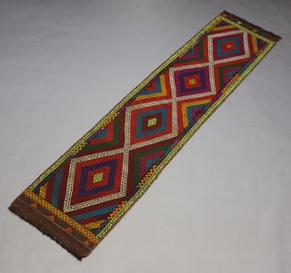A purple, red, green and black ground Suzni Kilim runner with 4 diamonds to the centre 248cm x 57cm 