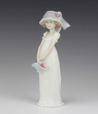 A Lladro figure, standing bonneted girl carrying basket of flowers, the base marked 2004 events creation