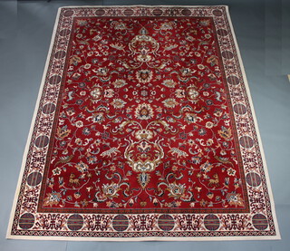 A red and white floral patterned Persian style machine made carpet 339cm x 251cm 