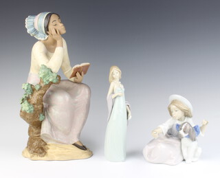 A matt Lladro figure of a seated girl reading a book impressed A9J 32cm, Lladro standing lady in evening dress 20cm and a ditto seated girl with puppy B27E 15cm (hand mirror missing)
