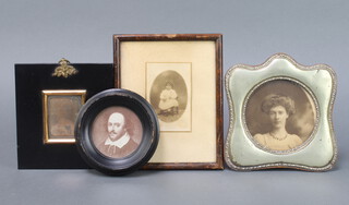 An early portrait photograph of a gentleman contained in an ebonised and gilt frame 6cm x 4.5cm, a London Stereoscopic Company portrait miniature of William Shakespeare 6cm contained in a circular frame, a photograph portrait of a lady in a silver plated frame 15cm x 15cm together with a black and white portrait photograph of a seated girl 9cm x 6cm  