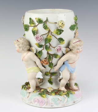 A Dresden style oil lamp, the base supported by cherubs 25cm h 