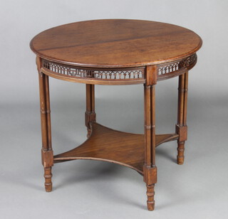 An Edwardian Chippendale style circular mahogany occasional table with pierced apron, raised on turned supports with shaped undertier 68cm h x 77cm diam. 