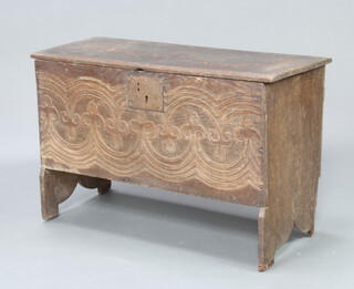 A 17th/18th Century oak coffer of plank construction with iron lock plate, carved decoration to the front 61cm h x 94cm w x 39cm d 