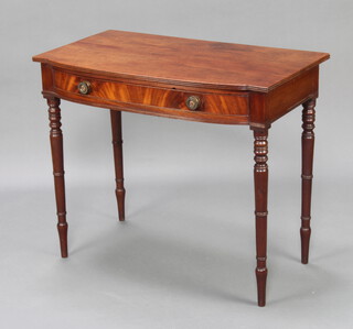 A Regency mahogany bow front side table fitted a frieze drawer raised on turned supports 77cm h x 92cm w x 52cm d 