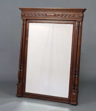 A 19th Century French rectangular bevelled plate mirror contained in a carved oak frame with moulded cornice, supported by 4 turned and fluted columns 109cm h x 82cm w x 9cm 