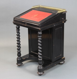 A Victorian ebonised Davenport desk, the upper section with pierced brass gallery, the interior fitted 2 short drawers above a dummy drawer, the pedestal fitted an inkwell drawer, 2 brushing slides and 4 drawers enclosed by panelled doors, raised on spiral turned supports 87cm h x 53cm w x 59cm d 