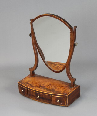 A 19th Century Sheraton style shield shaped dressing table mirror contained in a mahogany swing frame, raised on a bow front base, fitted 1 long and 2 short drawers with turned ivory handles 59cm h x 43cm w x 20cm d 