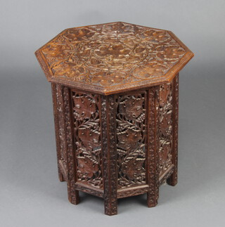 An Eastern octagonal carved and pierced hardwood table raised on a hinged folding stand 47cm h x 45cm w x 45cm d