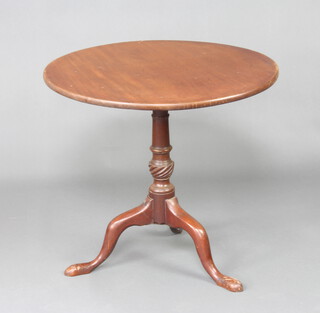 A Georgian circular mahogany snap top tea table raised on a turned column and tripod base 68cm h x 68cm diam. 