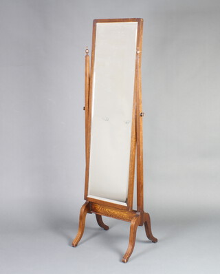 A 1930's rectangular bevelled plate cheval mirror contained in an oak swing frame 159cm h x 47cm 2 x 40cm d