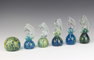 A Mdina circular green and gilt glass paperweight 6cm x 4cm together with 6 Mdina glass paperweights in the form of seahorses 