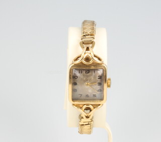 A lady's 9ct yellow gold wristwatch on an expanding gilt bracelet 