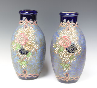 A pair of Continental Art Nouveau blue and floral glazed jugs 41cm 