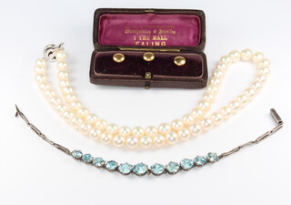 A string of cultured pearls with a silver clasp 42 cm, together with 3 18ct gold studs 2 grams and a gem set silver bracelet