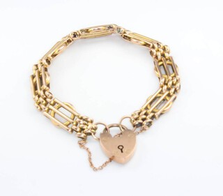 A 9ct yellow gold gate bracelet with heart locket, 15.4 grams