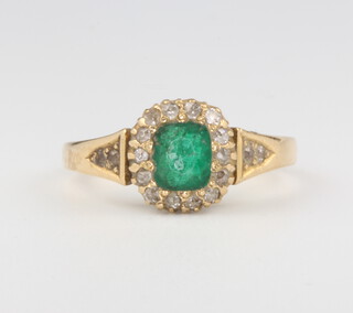 An 18ct yellow gold emerald and diamond cluster ring, size N, 4 grams