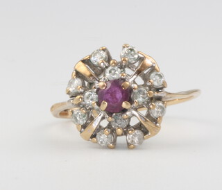 A 9ct yellow gold ruby and diamond cluster ring size K, 2 grams