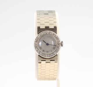 A lady's 9ct white gold cocktail watch with diamond set bezel, 36.8 grams gross